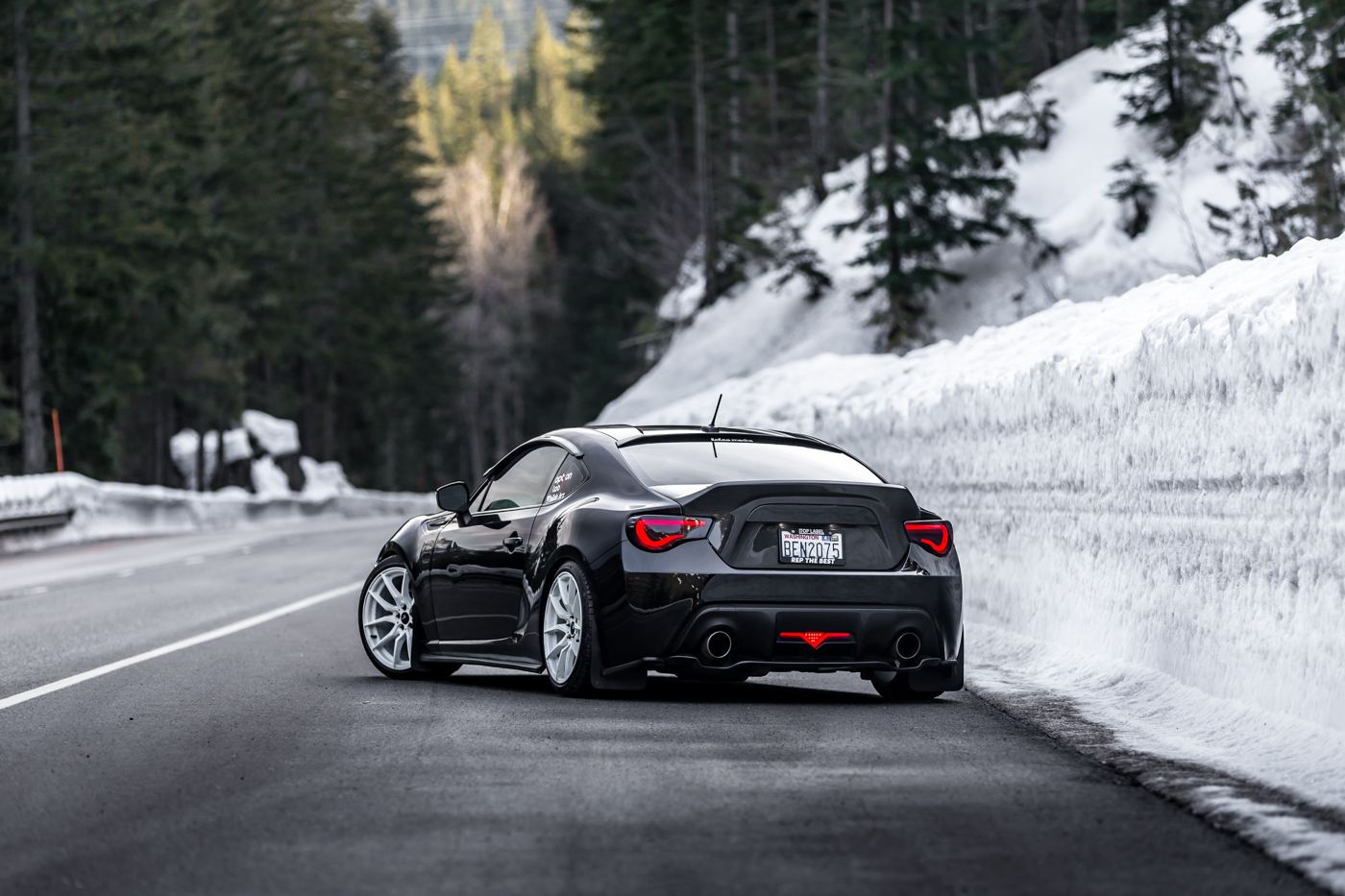 Black Subaru BRZ on a snowed-in mountain pass